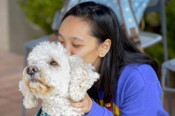 Girl kissing dog